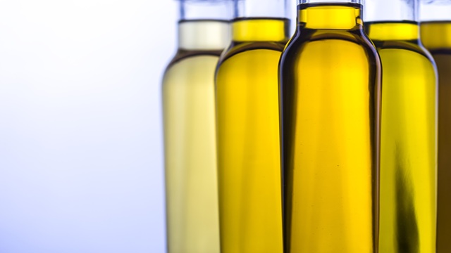 Oil in glass bottle on a white background